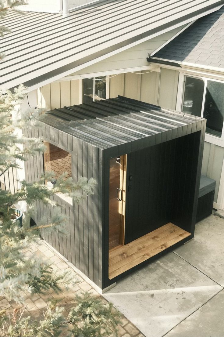 Dark modern sauna integrated against contemporary home exterior
